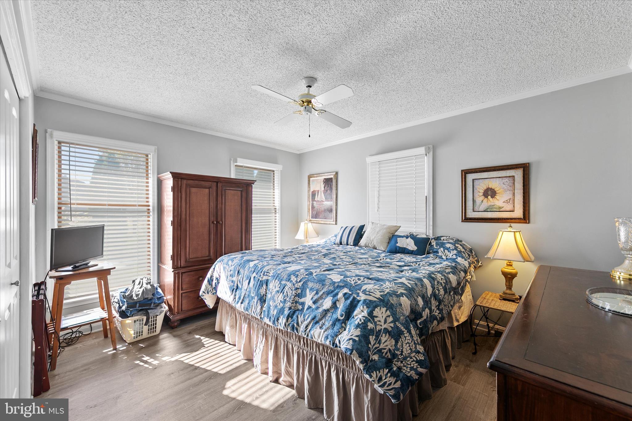 37239 Main Street Ocean View, DE 19970 - Photo 19 of 43 a bedroom with a bed and dresser with mirror