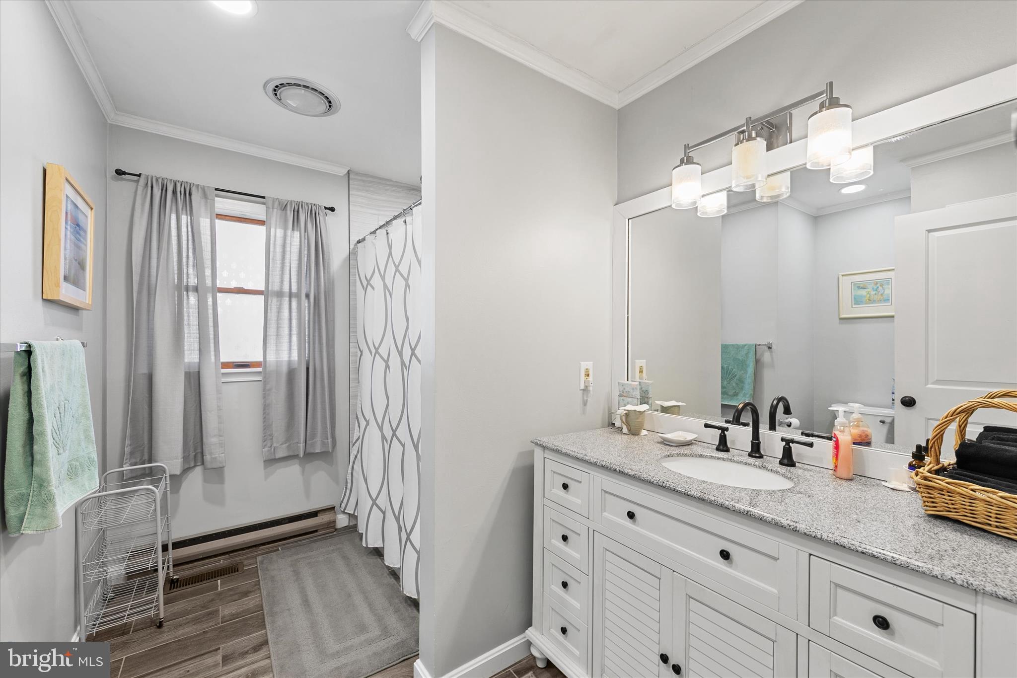 37239 Main Street Ocean View, DE 19970 - Photo 21 of 43 a bathroom with a double vanity sink mirror and shower