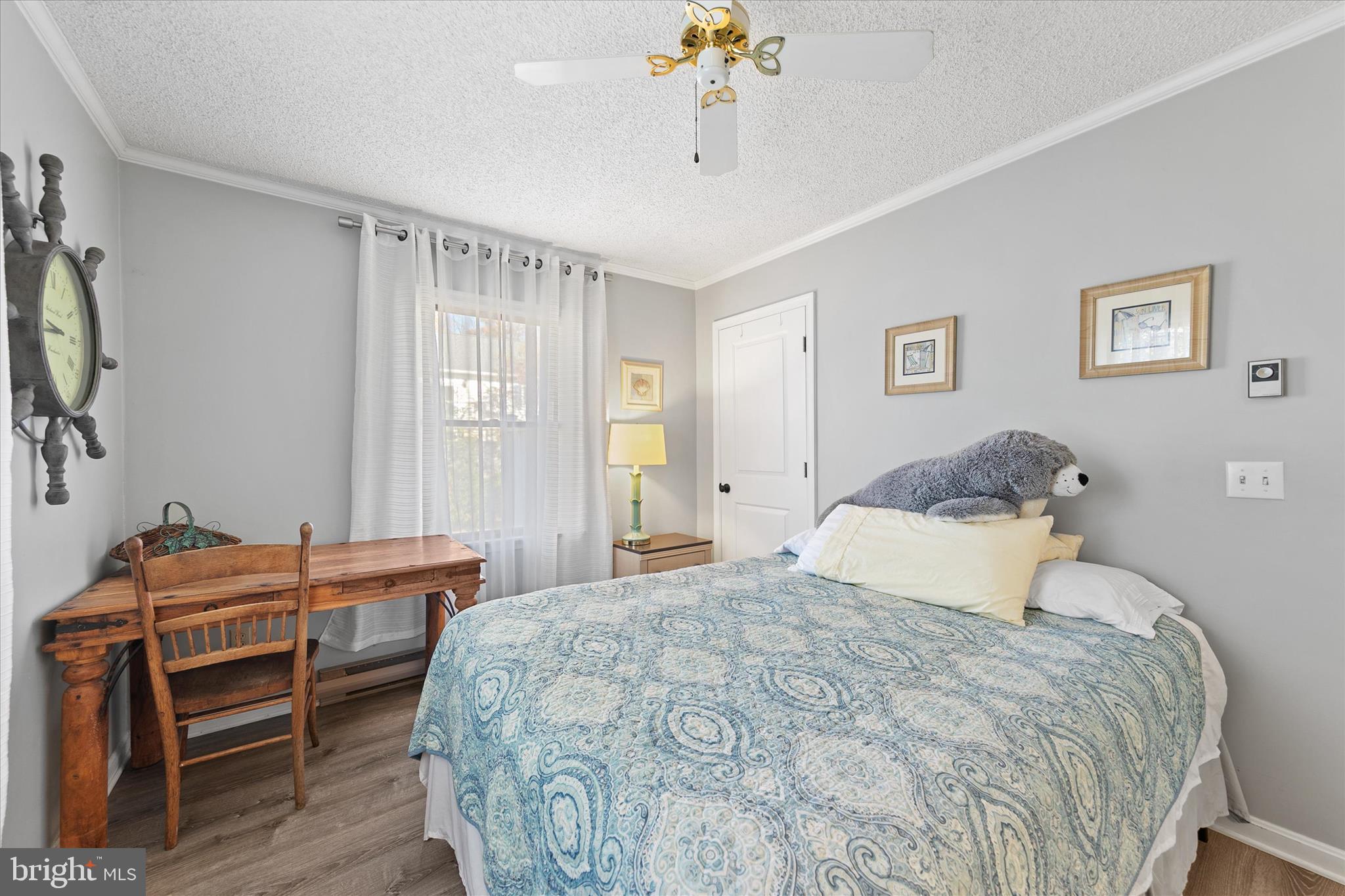37239 Main Street Ocean View, DE 19970 - Photo 22 of 43 a bedroom with a bed and a chandelier