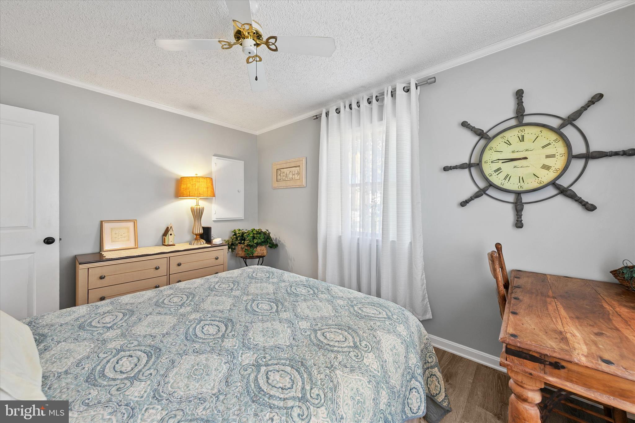 37239 Main Street Ocean View, DE 19970 - Photo 24 of 43 a bedroom with a bed and a chandelier