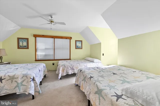 a bedroom with two beds and a window