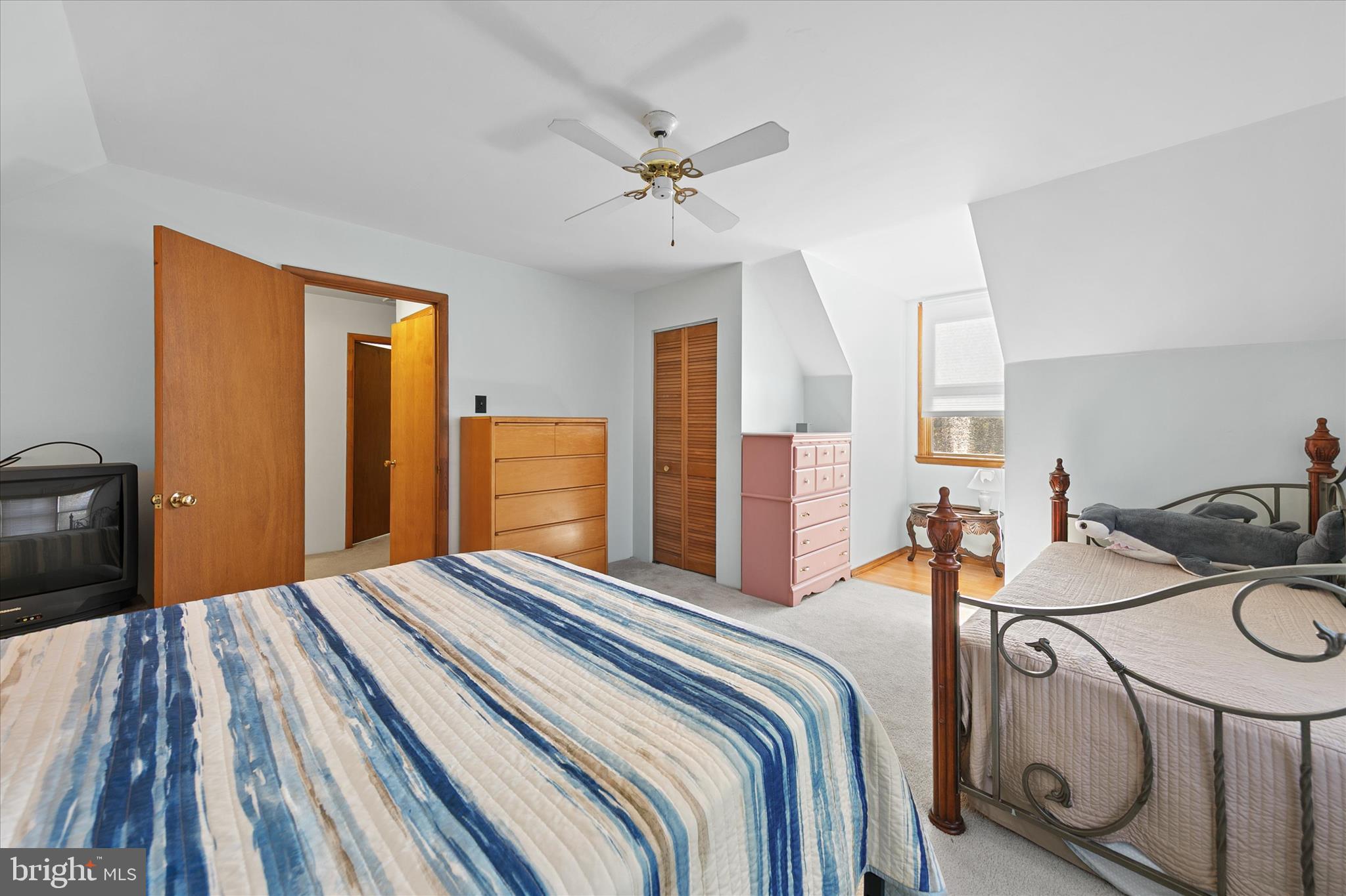 37239 Main Street Ocean View, DE 19970 - Photo 30 of 43 a bedroom with a bed and a chandelier