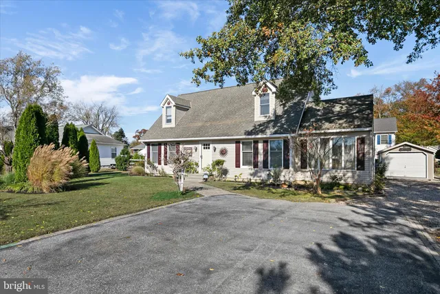 a view of a house with garden and sitting area