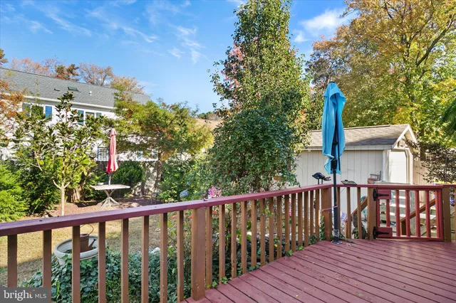 a balcony with wooden floor and fence