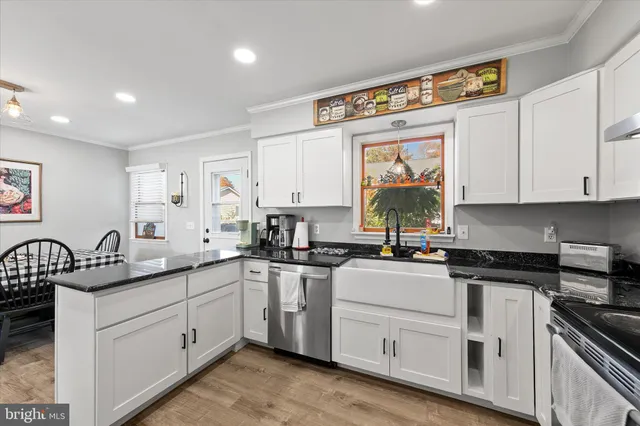 a kitchen with a sink stove and cabinets