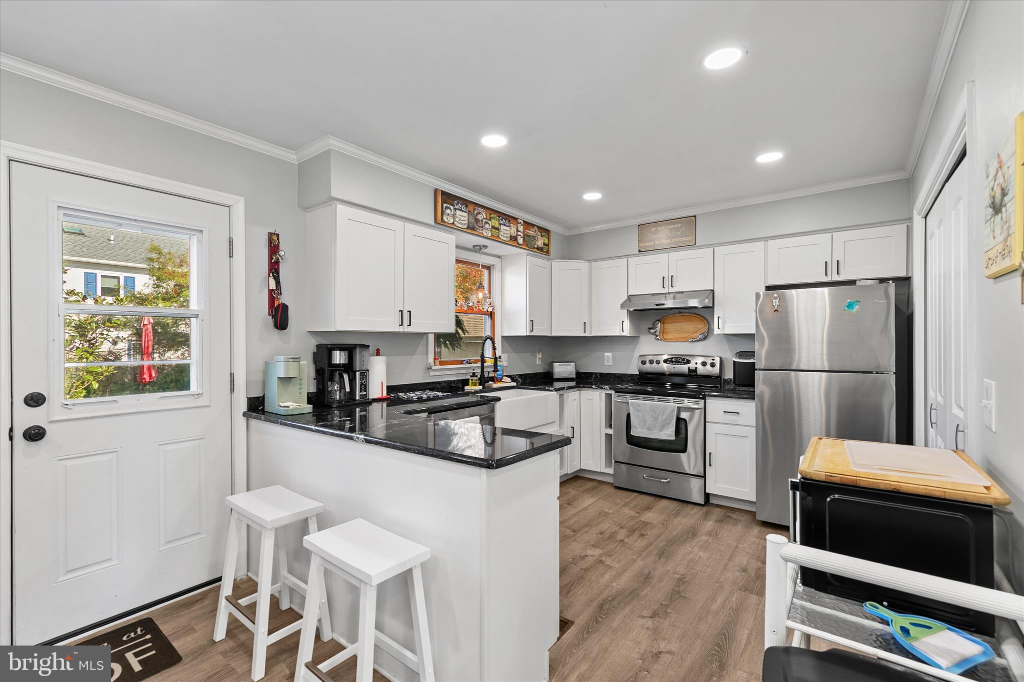 37239 Main Street Ocean View, DE 19970 - Photo 10 of 43 a kitchen with white cabinets and stainless steel appliances