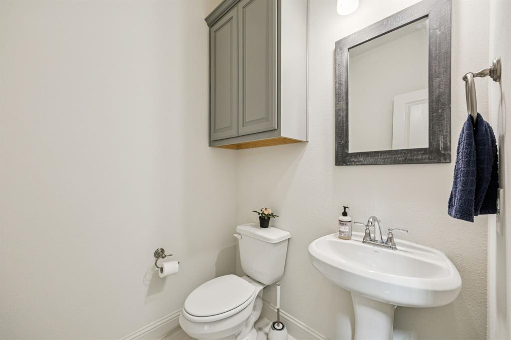 1010 Switchgrass Lane Allen, TX 75013 - Photo 11 of 25 a bathroom with a toilet sink and mirror