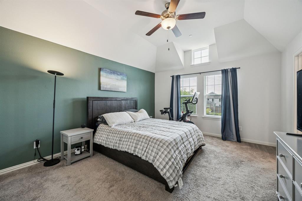 1010 Switchgrass Lane Allen, TX 75013 - Photo 14 of 25 a bedroom with a bed and a chandelier