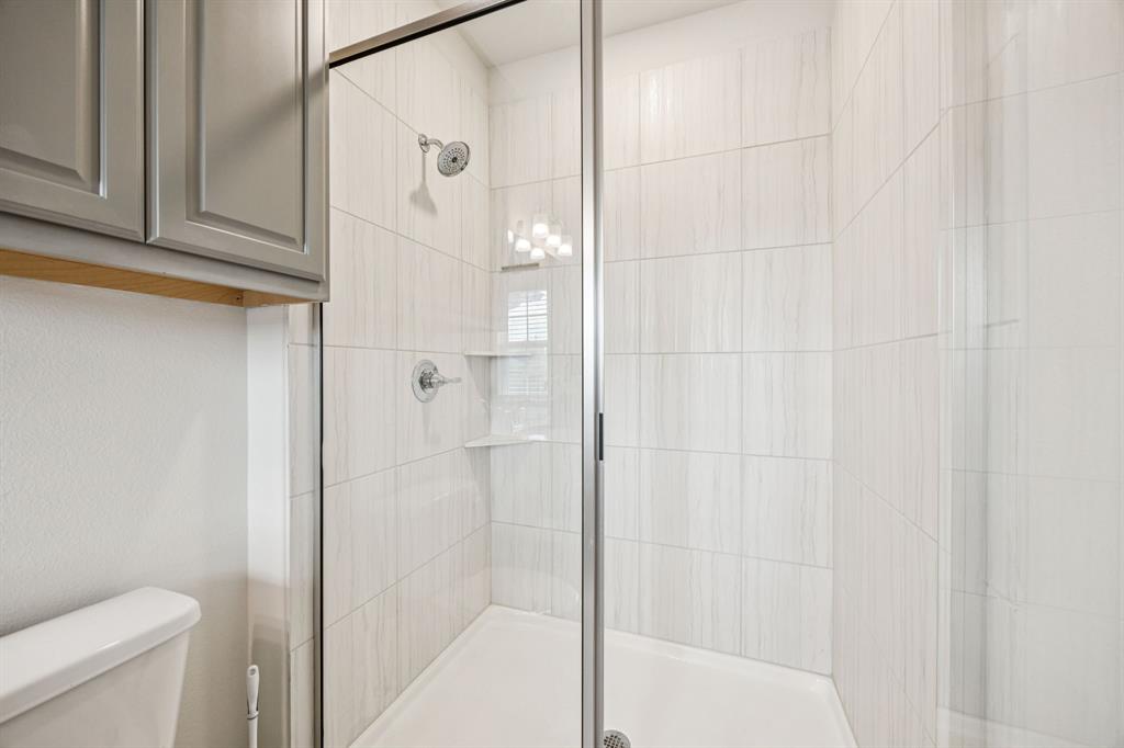 1010 Switchgrass Lane Allen, TX 75013 - Photo 19 of 25 a bathroom with a shower and a toilet