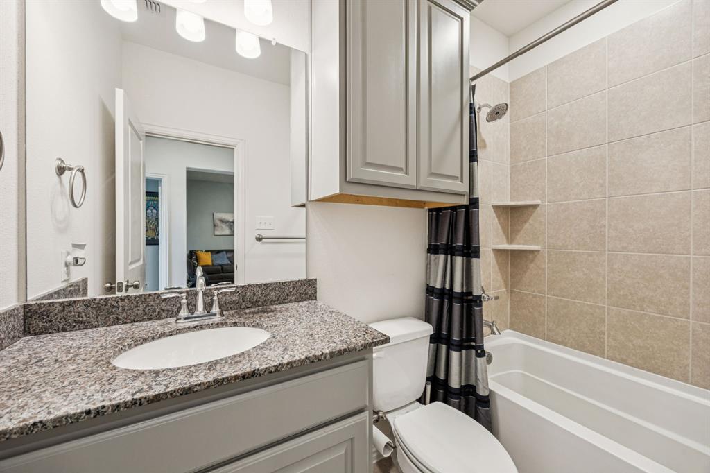 1010 Switchgrass Lane Allen, TX 75013 - Photo 20 of 25 a bathroom with a granite countertop sink toilet and shower