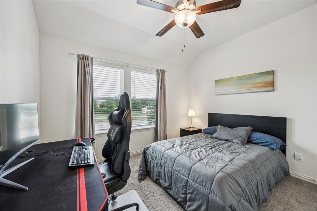 1010 Switchgrass Lane Allen, TX 75013 - Photo 21 of 25 a bedroom with a bed and a flat tv screen on the dresser