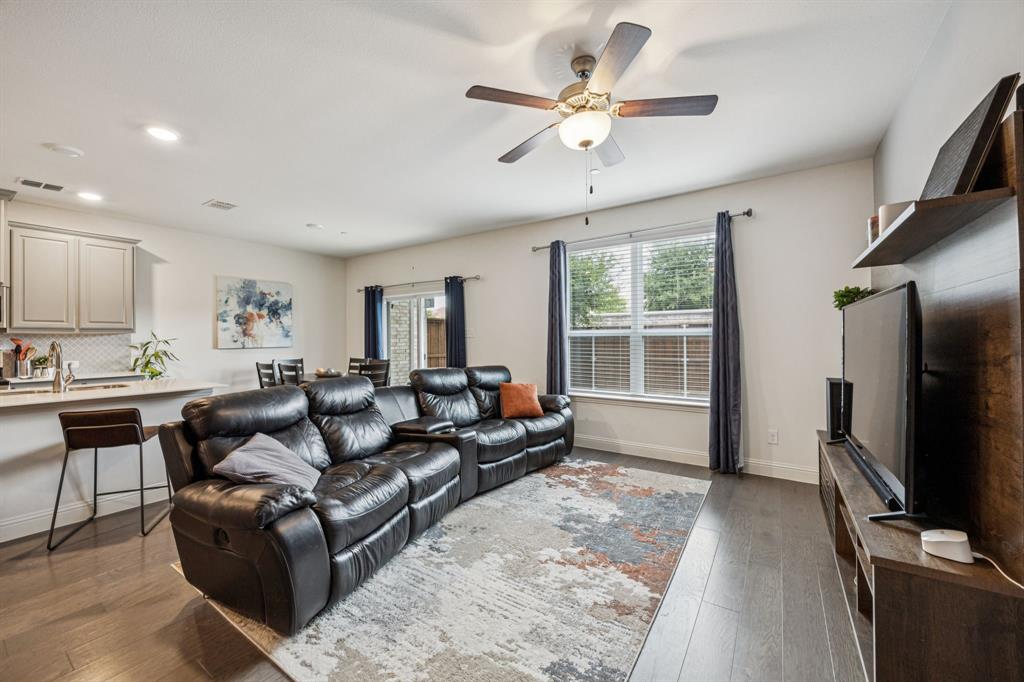 1010 Switchgrass Lane Allen, TX 75013 - Photo 3 of 25 a living room with furniture a large window and a flat screen tv