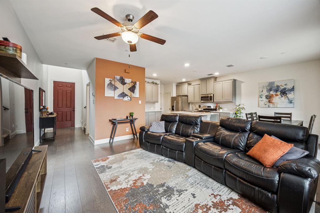 1010 Switchgrass Lane Allen, TX 75013 - Photo 7 of 25 a living room with furniture kitchen view and a wooden floor