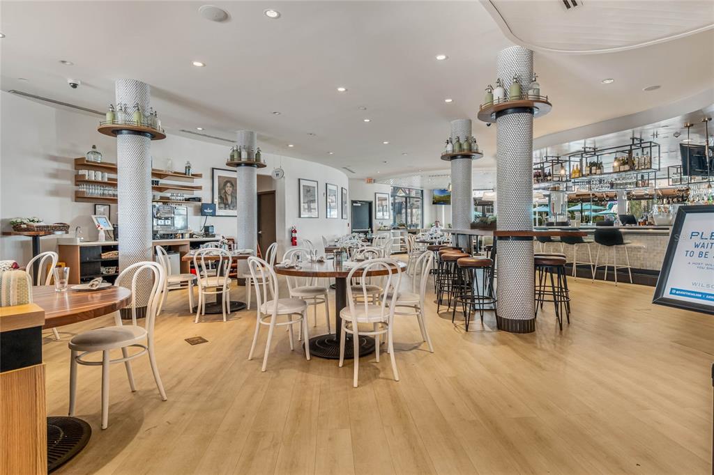 225 Celebration Place, Unit 117 Celebration, FL 34747 - Photo 17 of 30 a living room with lots of furniture and kitchen view