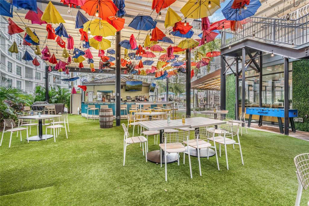 225 Celebration Place, Unit 117 Celebration, FL 34747 - Photo 19 of 30 a table and chairs in front of a building
