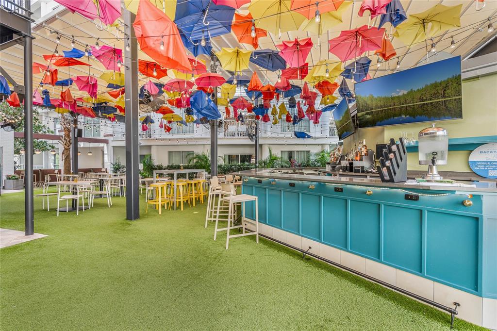 225 Celebration Place, Unit 117 Celebration, FL 34747 - Photo 20 of 30 a view of swimming pool with chairs in front of building
