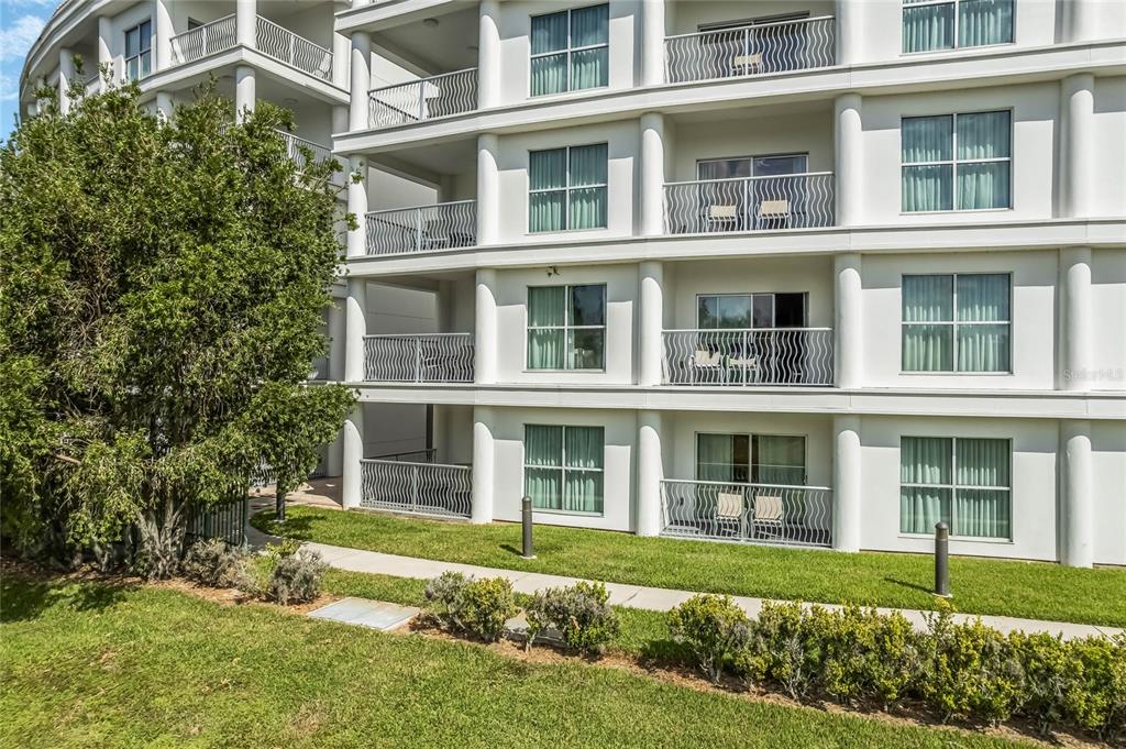 225 Celebration Place, Unit 117 Celebration, FL 34747 - Photo 24 of 30 a large brick building with a garden