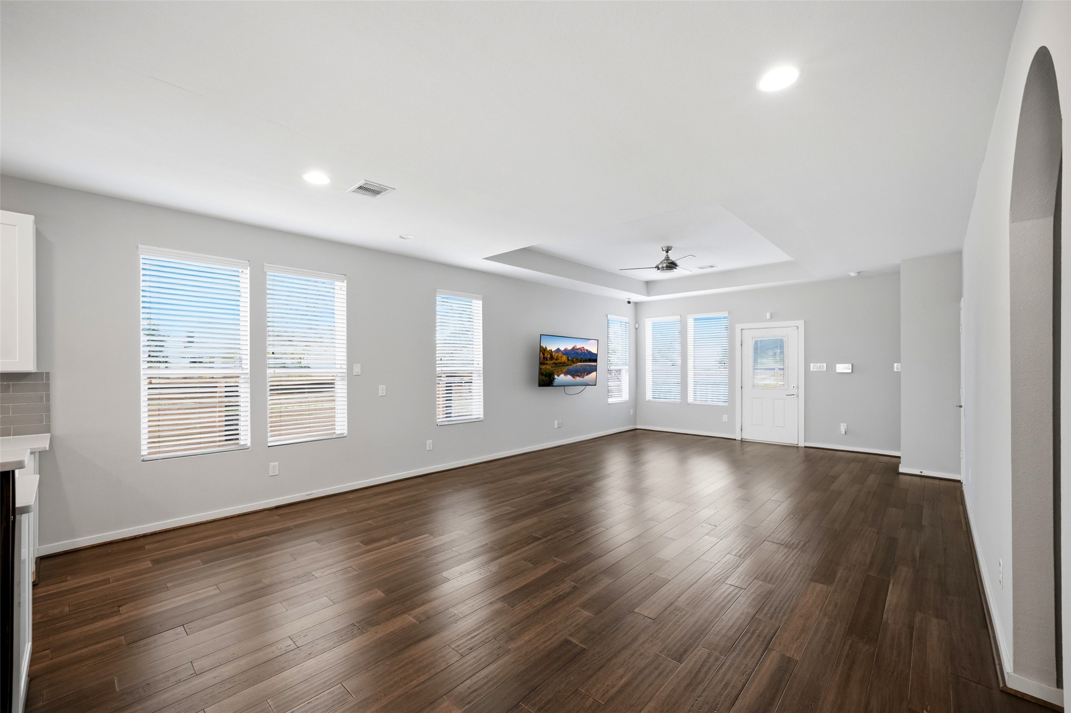 605 Dumble Street Houston, TX 77023 - Photo 14 of 44 an empty room with wooden floor and windows