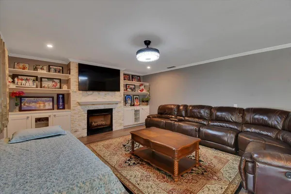 a living room with furniture a flat screen tv and a fireplace