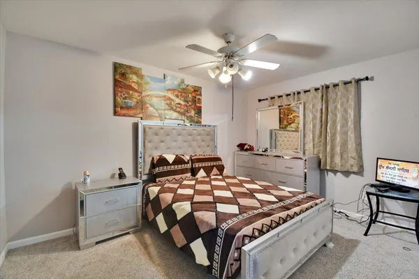 a bedroom with a bed and a chandelier