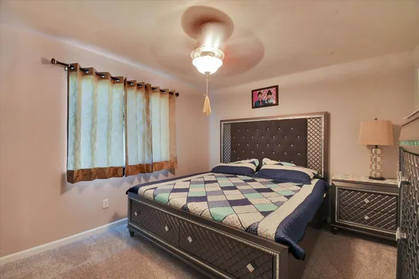 a bedroom with a bed and a chandelier