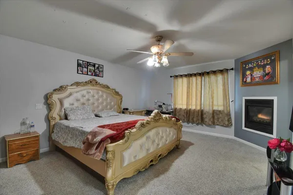 a bedroom with a bed and a fireplace