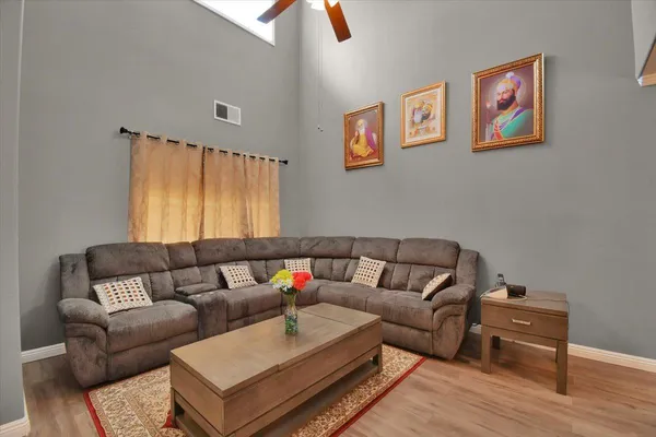 a living room with furniture and a wooden floor