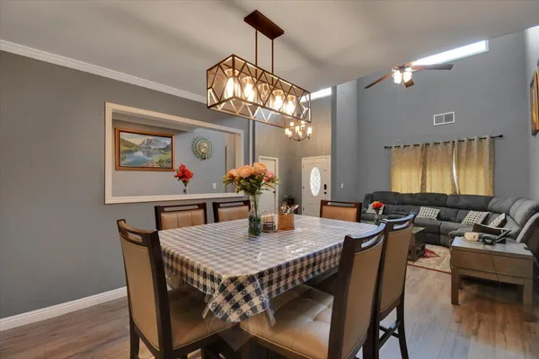 a view of a dining room with furniture wooden floor and chandelier
