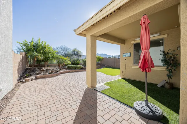 a green field with lots of trees in front of it