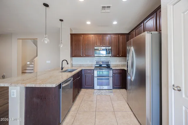 a kitchen with refrigerator and window