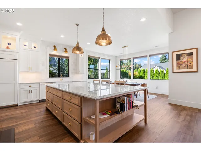 a kitchen with stainless steel appliances a stove a sink island and a refrigerator