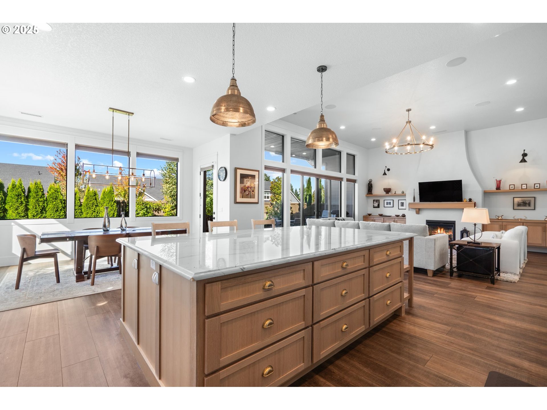 3911 Northwest 114th Street Vancouver, WA 98685 - Photo 6 of 30 a kitchen with kitchen island granite countertop a stove a oven a dining table and chairs with wooden floor
