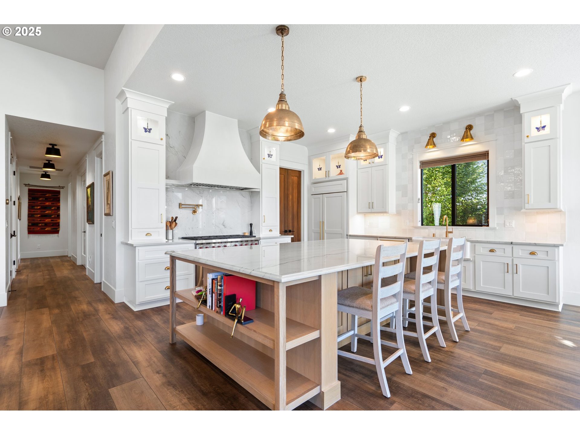 3911 Northwest 114th Street Vancouver, WA 98685 - Photo 7 of 30 a kitchen with stainless steel appliances granite countertop a stove oven a dining table and chairs with wooden floor