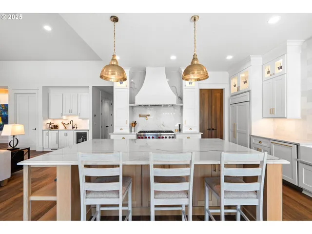 a kitchen with stainless steel appliances granite countertop a stove and a refrigerator