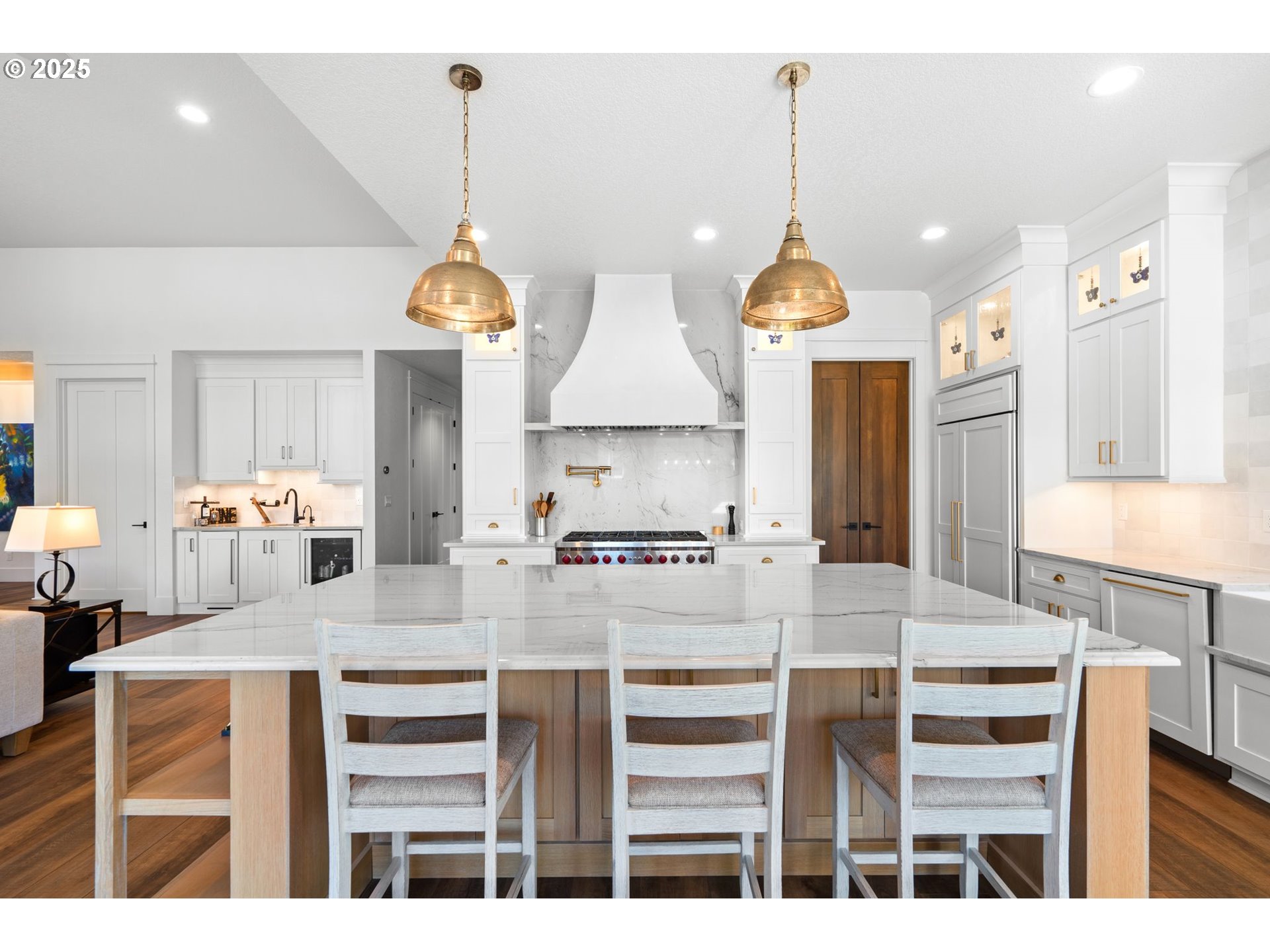 3911 Northwest 114th Street Vancouver, WA 98685 - Photo 8 of 30 a kitchen with kitchen island granite countertop a stove a sink a dining table and chairs