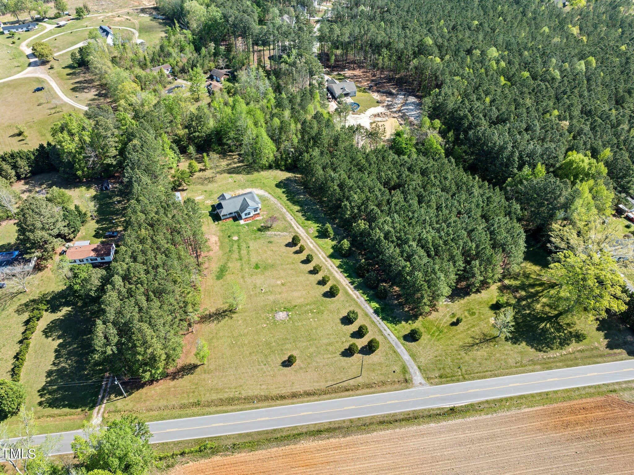 665 Lewis Road Zebulon, NC 27597 - Photo 4 of 29 an aerial view of a residential houses with yard