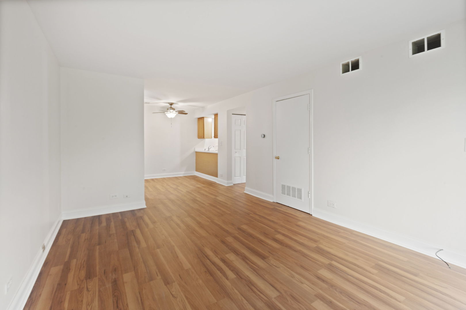 1975 Kenilworth Circle, Unit B Hoffman Estates, IL 60169 - Photo 12 of 21 a view of empty room with wooden floor