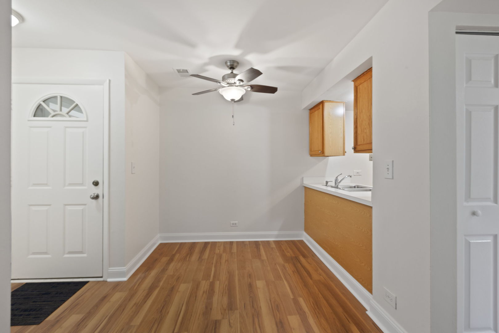 1975 Kenilworth Circle, Unit B Hoffman Estates, IL 60169 - Photo 13 of 21 a view of a kitchen with wooden floor and a ceiling fan
