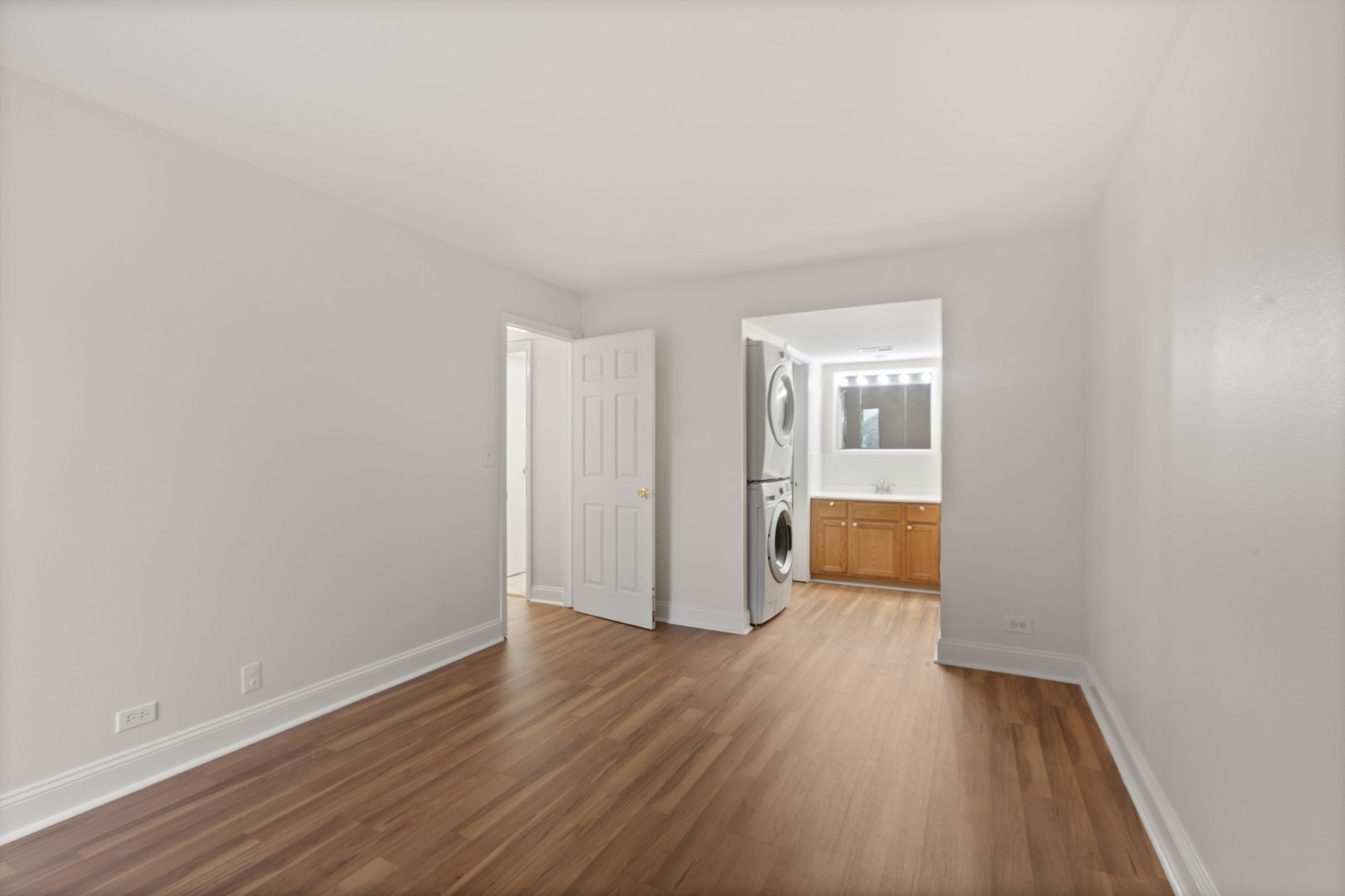 1975 Kenilworth Circle, Unit B Hoffman Estates, IL 60169 - Photo 16 of 21 a view of a room with wooden floor and a bathroom