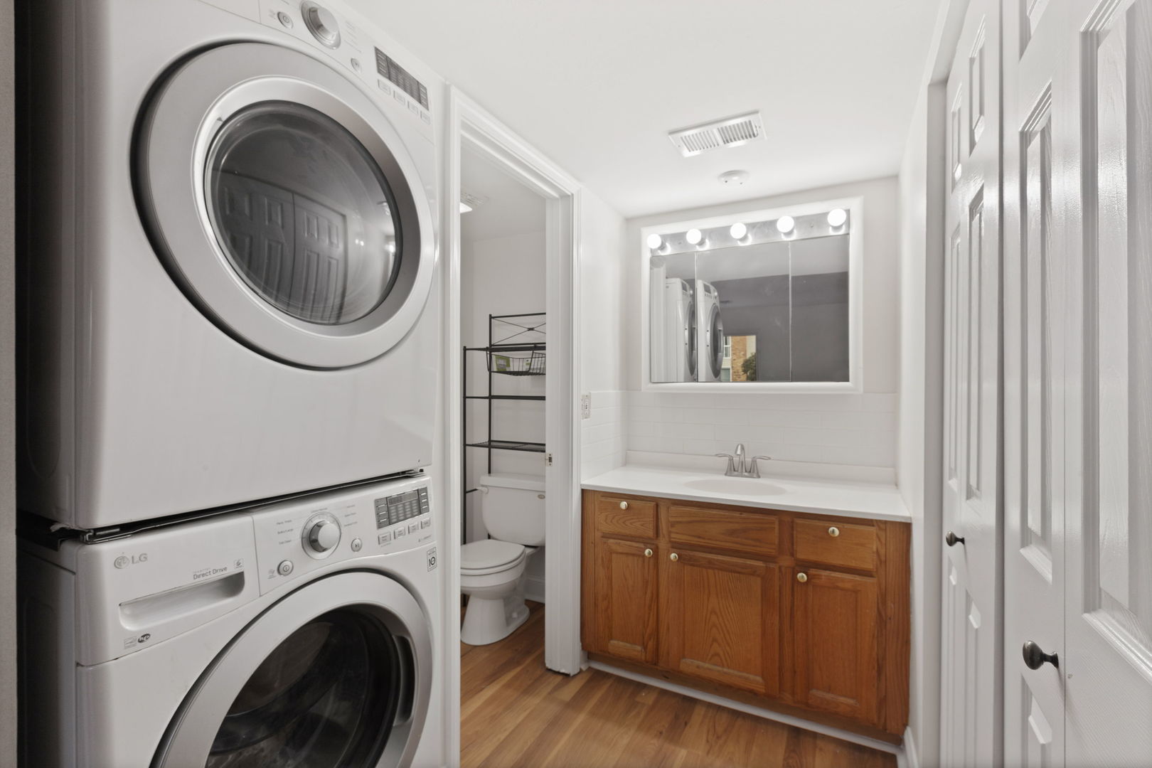 1975 Kenilworth Circle, Unit B Hoffman Estates, IL 60169 - Photo 8 of 21 a view of a bathroom with washing machine and sink