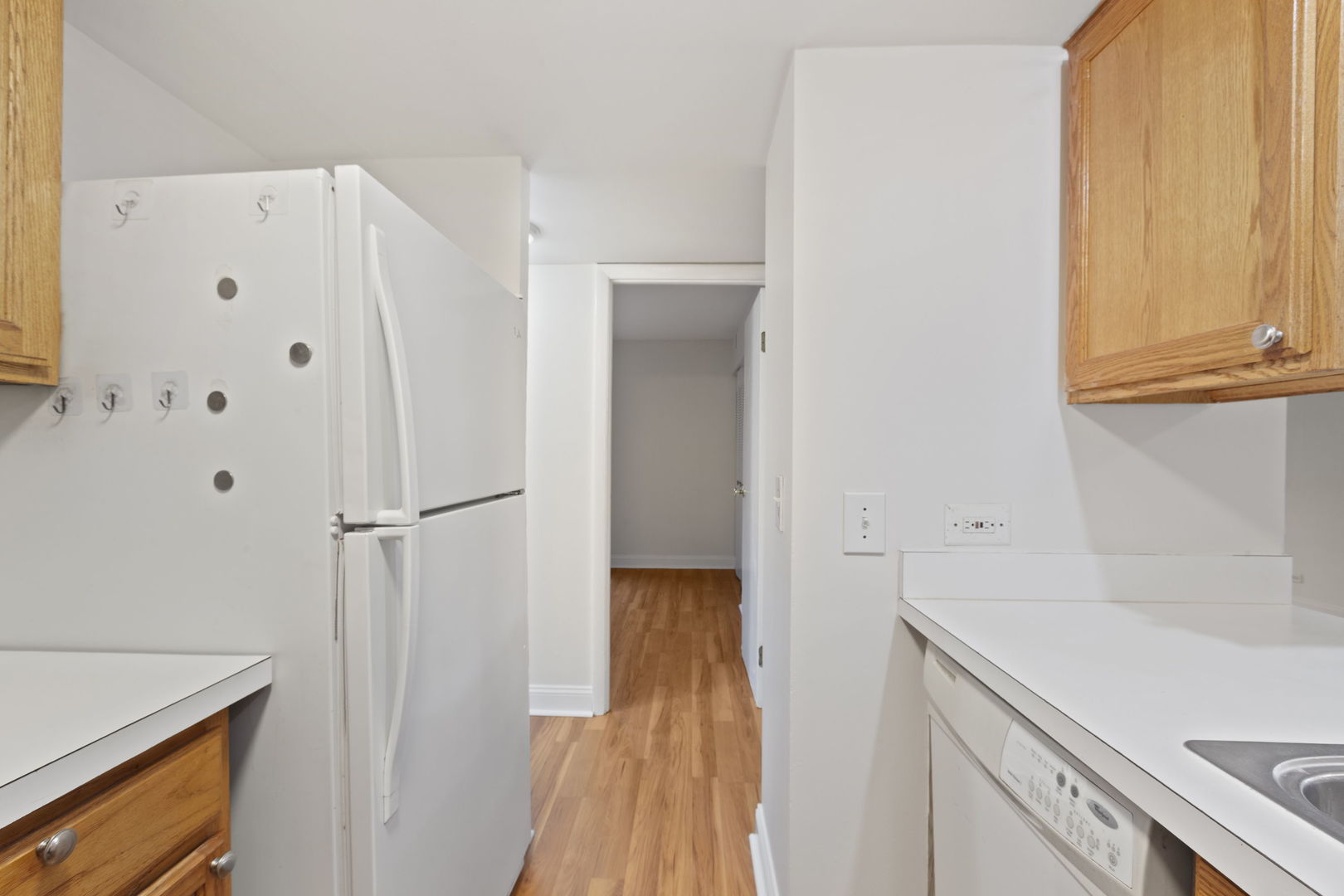 1975 Kenilworth Circle, Unit B Hoffman Estates, IL 60169 - Photo 10 of 21 a hallway with sliding door and wooden cabinets