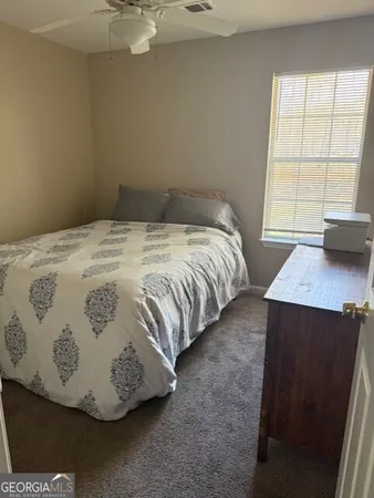 a bedroom with furniture and a flat screen tv