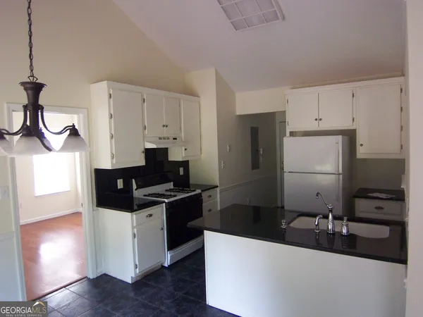 a kitchen with stainless steel appliances a sink a stove and refrigerator