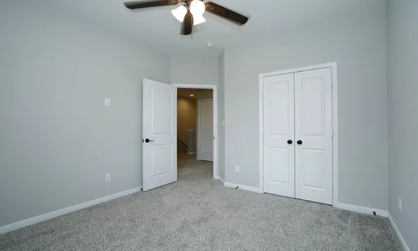 an empty room with a empty space and a ceiling fan