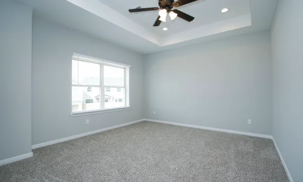 an empty room with a ceiling fan and a window
