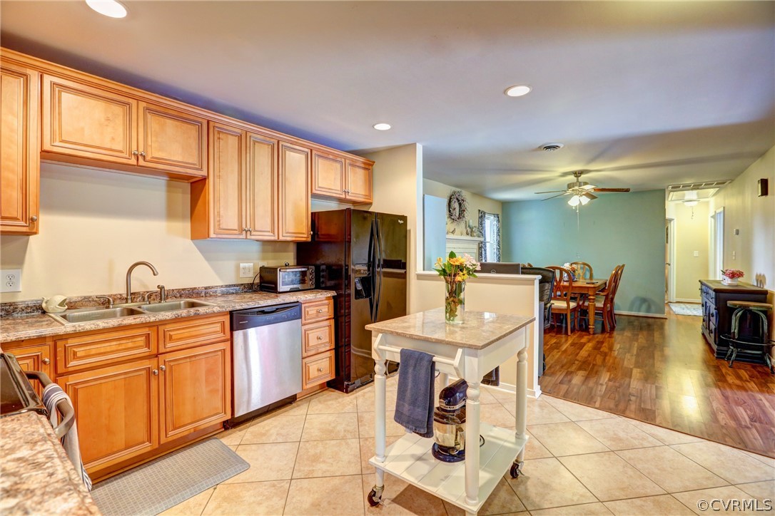 3909 Bronholly Road Chesterfield, VA 23832 - Photo 16 of 38 a open kitchen with stainless steel appliances kitchen island granite countertop a refrigerator a sink dishwasher a dining table and chairs with wooden floor