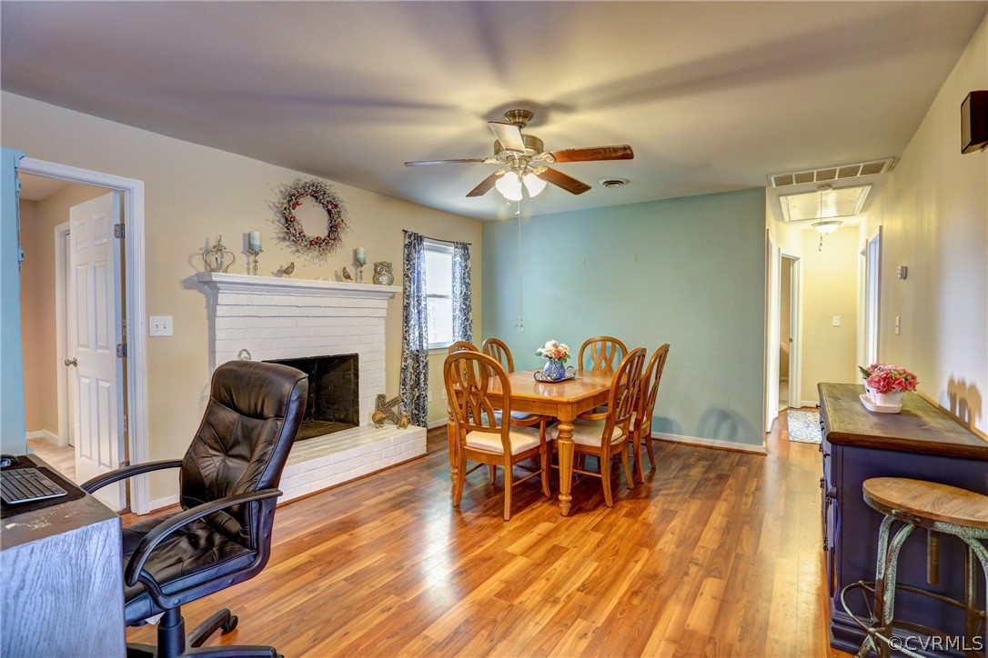 3909 Bronholly Road Chesterfield, VA 23832 - Photo 20 of 38 a dining room with furniture a fireplace and wooden floor