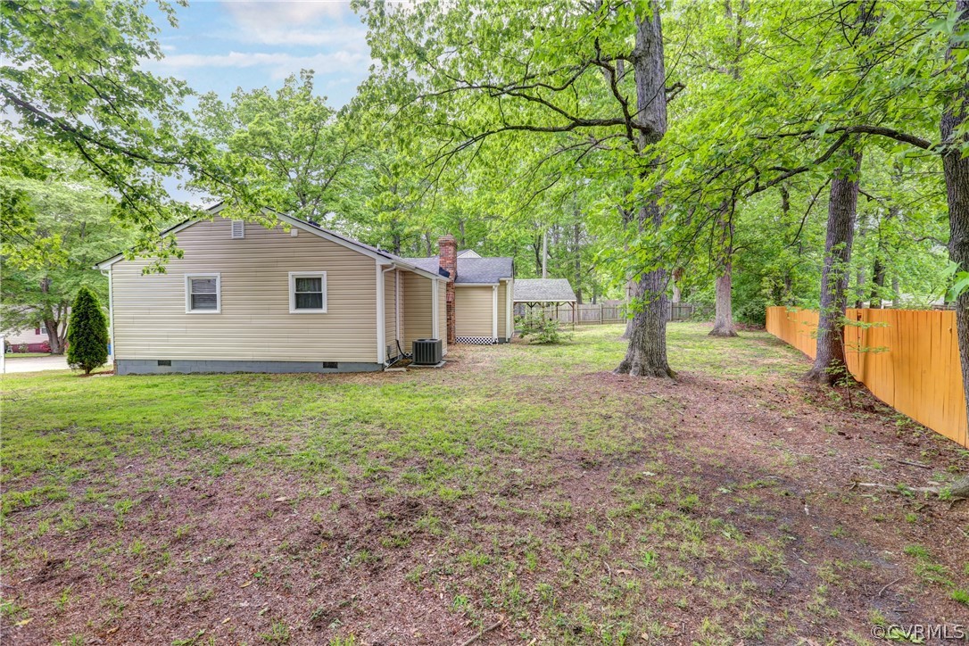 3909 Bronholly Road Chesterfield, VA 23832 - Photo 35 of 38 a backyard of a house with plants and large tree