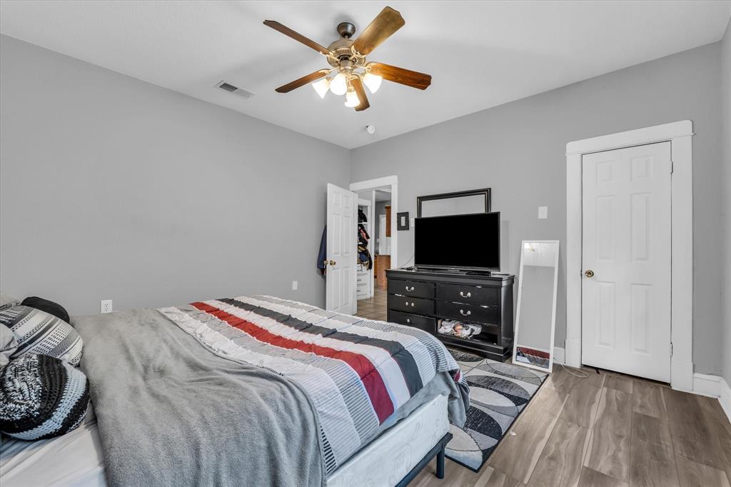 1822 Herring Avenue Waco, TX 76708 - Photo 14 of 26 a bedroom with a bed and a flat screen tv