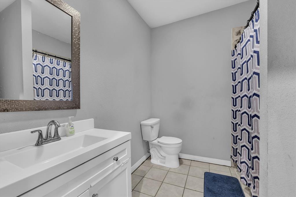 1822 Herring Avenue Waco, TX 76708 - Photo 17 of 26 a bathroom with a sink toilet and shower